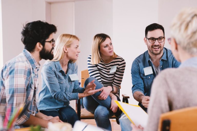 group of people discussing benefits of group therapy