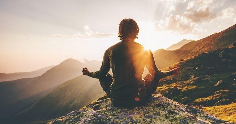 Man Meditating Mindfullness on Cliff Mountain view - Long-Term Recovery Through Meditation