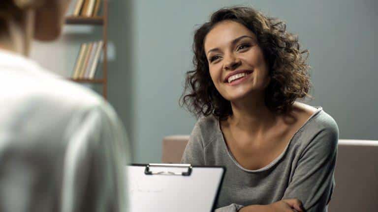 Young,Happy,Lady,Talking,With,Psychologist,At,Clinic,,Session,Of