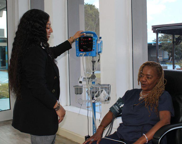 A nurse checking vital signs for a patient at Pines Recovery Life